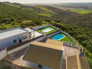an aerial view of a house with two swimming pools at Casa Bellavistas in Vejer de la Frontera +24 photos