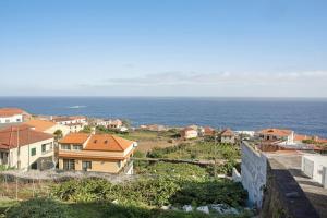 a view of a town with the ocean in the background at Seaside Haven - Soulful Stays in Porto Moniz