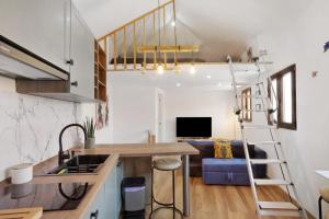 a kitchen and living room with a loft at Seaside Haven - Soulful Stays in Porto Moniz