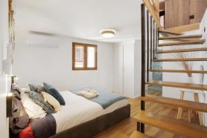 a bedroom with a bed and a staircase at Seaside Haven - Soulful Stays in Porto Moniz