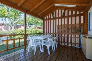 a porch with a table and chairs on a deck at Bungalow E in Pontevedra