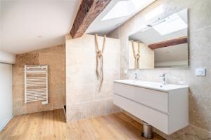 a bathroom with a sink and a mirror at Le Somail - Louis 14 in Ginestas +17 photos