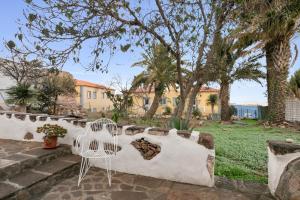 a white chair sitting on a stone wall at Casa Canaria Finca Real in Las Lagunas