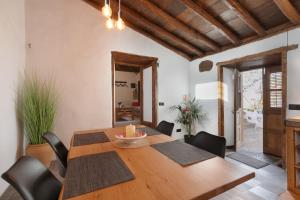 a dining room with a wooden table and chairs at Casa Canaria Finca Real in Las Lagunas +24 photos