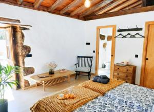 a bedroom with a bed and a table and a chair at Casa Canaria Finca Real in Las Lagunas