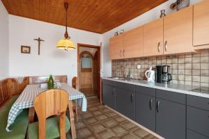 a kitchen with a table and a dining room at Regalterhof Eppan in San Paolo