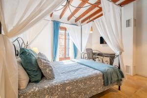 a bedroom with a bed with a canopy at Cas Mercader in Algaida +30 photos
