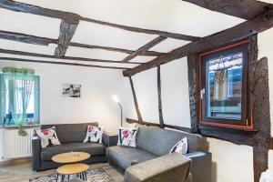 a living room with a couch and a table at Ferienwohnung Altstadtblick in Alsfeld