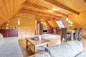 a living room with a couch and a table at Feriendomizil Fliedereck in Malchin
