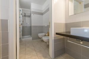 a bathroom with a toilet and a sink at Il Nazareno - Il Gheppio in Cecina +20 photos