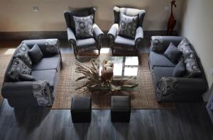 a living room with two couches and an owl on a table at Hemel Bushveld Lodge in Vaalwater