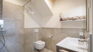 a bathroom with a shower and a toilet and a sink at Meine Bleibe Apartment Olive in Appiano sulla Strada del Vino +19 photos