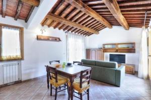 a living room with a table and a couch at Casa Consuelo App. 2 (trilocale) in Capoliveri