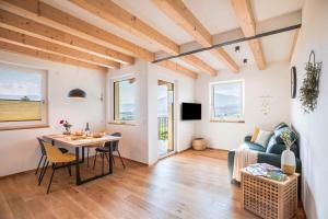 a living room with a table and a couch at Meine Bleibe Apartment Olive in Appiano sulla Strada del Vino