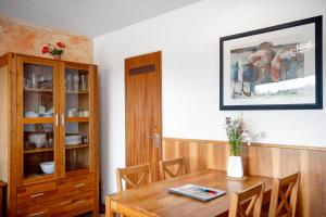 a dining room with a table and a cabinet at Ferienwohnung Bergrose in Obermaiselstein