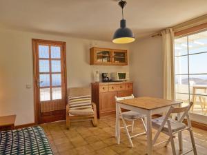 a kitchen and dining room with a table and chairs at Finca La Calerita B in Uga +9 photos