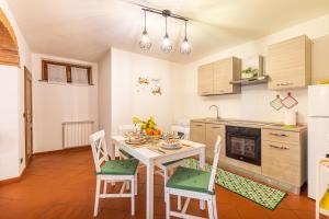 a kitchen with a table and chairs in a room at Il colle dei Frati in Sinalunga +14 photos