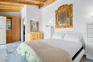a bedroom with a bed and a mirror on the wall at Villa Maryna in Olbia +24 photos