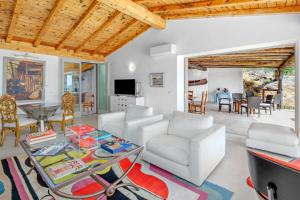 a living room with a white couch and a table at Villa Maryna in Olbia