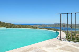 a swimming pool with a view of the ocean at Villa Maryna in Olbia
