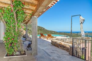 a patio with a view of the ocean from a house at Villa Maryna in Olbia