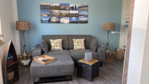 a living room with a couch and a tv at Ferienwohnungen Felix und Jan in Horumersiel