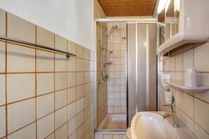 a bathroom with a toilet and a sink and a shower at Ferienwohnung Karin in Schonach +20 photos