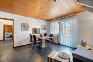 a dining room and living room with a table and chairs at Ferienwohnung Karin in Schonach