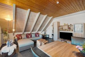 a living room with a couch and a table at Ferienwohnung Karin in Schonach