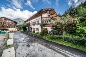 an old house on a street in the mountains at Chalet Ermena in Saint-Jean-d'Aulps