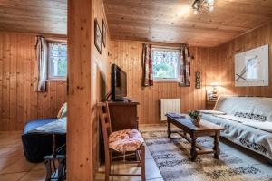 a bedroom with a bed and a desk and a tv at Chalet Ermena in Saint-Jean-d'Aulps