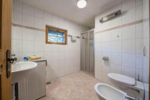 a bathroom with two sinks and a toilet and a shower at Untervernatsch Fewo Ötzi in Senales +17 photos