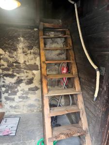a wooden ladder in a room with a fire hydrant at Untervernatsch Fewo Ötzi in Senales