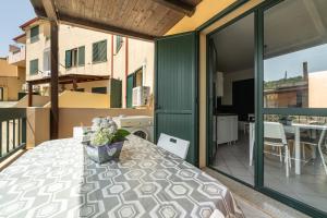 a balcony with a table and a view of a building at Casa Vacanza Casi 2 in Villasimius