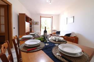 a dining room with a table with plates and wine glasses at Casa Zara a Otranto in Otranto +28 photos