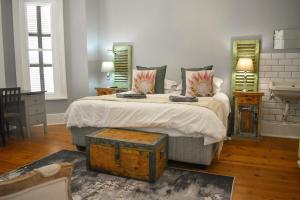 a bedroom with a large bed with a wooden floor at Little Lamb in Beaufort West +90 photos