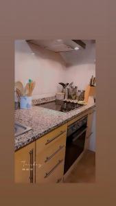 a kitchen with a stove and a counter top at Ká T'Espero in Penha Garcia