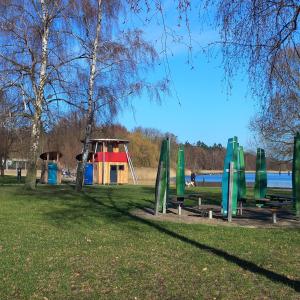 a park with a playground and a play structure at Haus Seeblick in Malchow