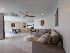 a living room with a couch and a table at Coconut Villa 8 in Ban Thung
