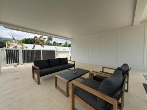 a living room with two couches and a table at Coconut Villa 8 in Ban Thung