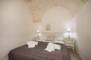 a bedroom with a large bed with two pillows at Casa Pà in Ostuni