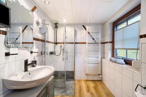 a bathroom with a sink and a shower at Ferienwohnung im Salzgässle in Schonach +21 photos