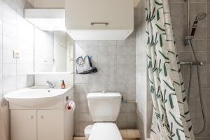 a bathroom with a toilet and a sink and a shower at Les cybeles - studio 3 personnes in Brides-les-Bains +15 photos