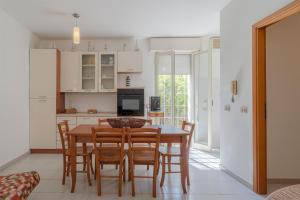 a kitchen and dining room with a table and chairs at Villa Amore - San Lorenzo in Reitani