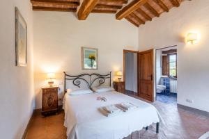a bedroom with a large white bed in a room at Agriturismo Paugnano in Radicondoli +111 photos
