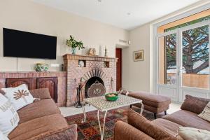 a living room with a couch and a fireplace at Villa Chantegrive in Roquebrune-sur-Argens