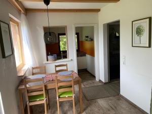 a kitchen and dining room with a table and chairs at Lieblingsplatz in Weiler-Simmerberg