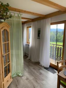 a room with white curtains and a large window at Lieblingsplatz in Weiler-Simmerberg