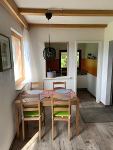 a dining room with a table and two chairs at Lieblingsplatz in Weiler-Simmerberg +14 photos
