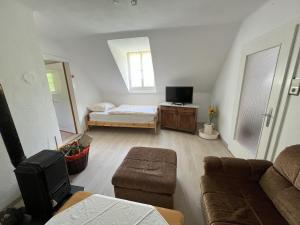 a living room with a couch and a bed at Ferienhaus Maierhofer in Fischbach